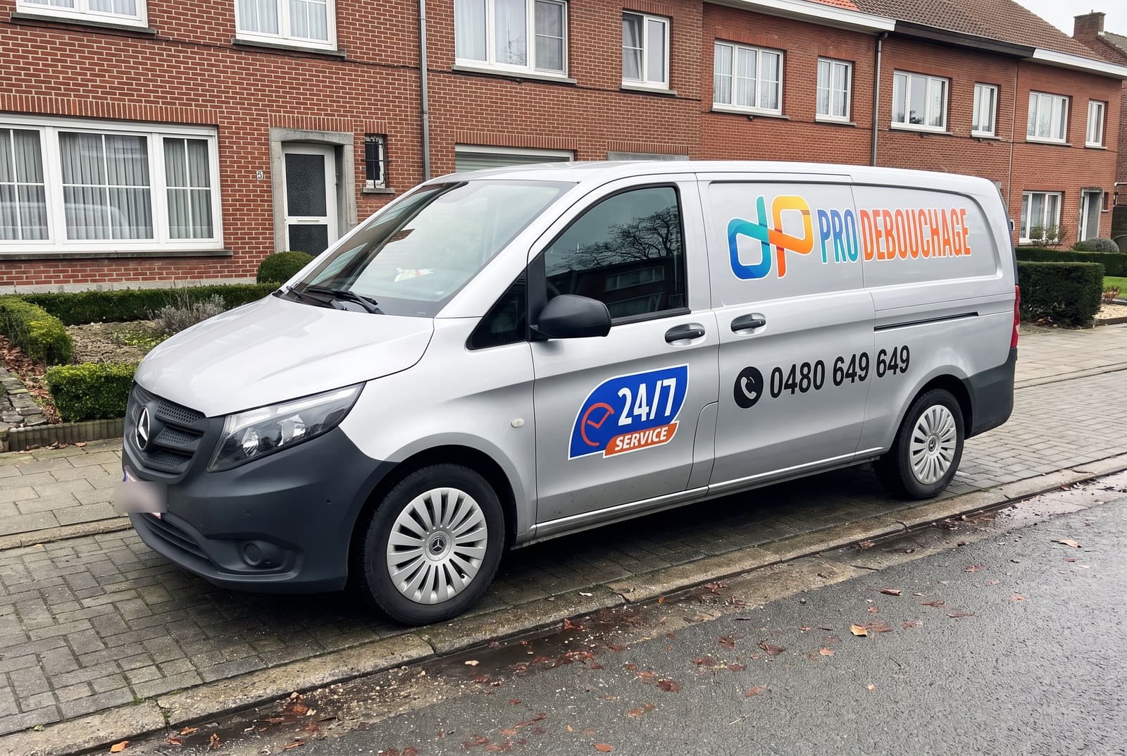 The Pro Débouchage van, a grey Mercedes Vito, parked on a Belgian residential street.